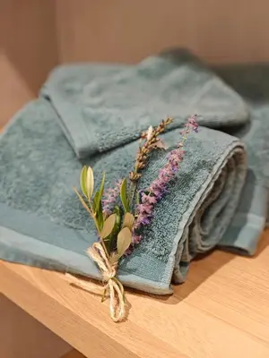 a blue towel with flowers on top of a table at Mas Sourso in Eygalières