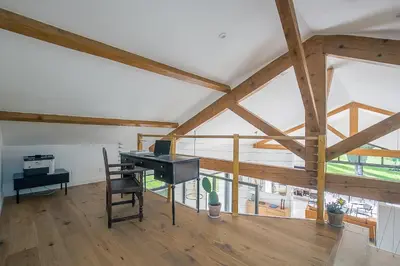 an attic room with a desk and a table at Mas Etienne Piscine&Nature Saint-Rémy Conciergerie in Saint-Rémy-de-Provence