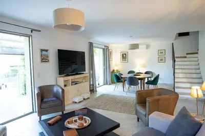 a living room with a couch and a table at Villa Cocoon Lourmarin in Lourmarin