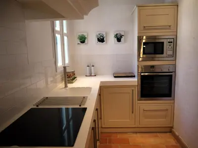 a kitchen with a sink and a microwave at La Bergerie Provencale - Luberon - Provence - villa with heated pool in Roussillon