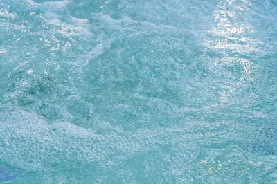 a close up of a body of water at Le Chant des Pins Lodge & Spa Tour de Keyrié in La Mignarde