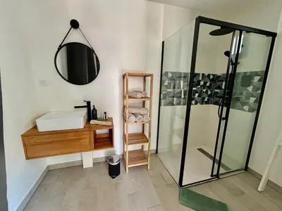 a bathroom with a toilet and a sink at Noyau & Pepin in Rognes