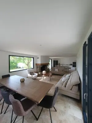 a living room with a table and a couch at Mas du Tilleul - LUBERON in Cadenet