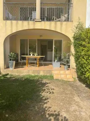 a bedroom with a large bed and a dresser at Vue lac avec accès piscine à vague in Mallemort