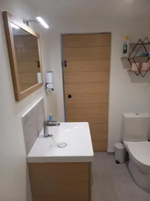 a bathroom with a sink and a toilet and a door at Bienvenue en Provence in Monteux