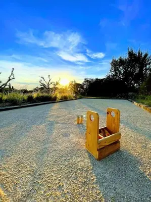 a wooden object sitting in the middle of a road at Mas de charme avec piscine au coeur des Alpilles in Eygalières