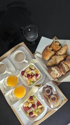 a table topped with plates of pastries and other foods at Spa NESSA in Saint-Andiol