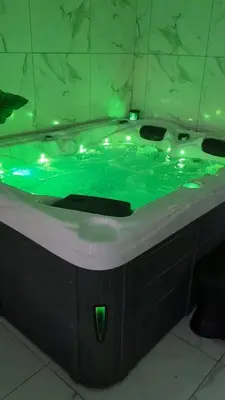 a bath tub with green water in a bathroom at Spa NESSA in Saint-Andiol