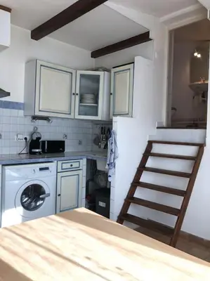 a room with a staircase and a sink and a door at Studio Proche L'Isle sur Sorgue in Le Thor