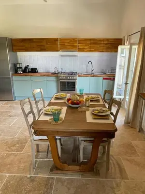 a kitchen with a wooden table with food on it at Appartement centre Apt Bèlavista luberon in Apt