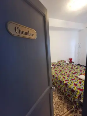 a door leading to a bedroom with a bed at Petit appart entier au cœur des REMPARTS - Netfix et connection fibre gratuits in Carpentras