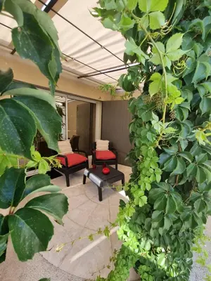 a living room with red chairs and plants at Ma Charmante Maison En Provence in Lançon-Provence