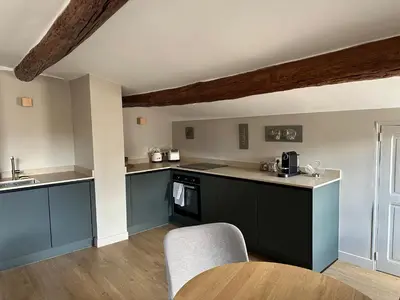 a kitchen with blue cabinets and a wooden floor at CABADOL - Appartement Aix centre historique - très calme - 50m cours Mirabeau in Aix-en-Provence
