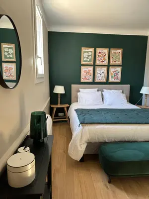 a bedroom with a bed and a table and a mirror at CABADOL - Appartement Aix centre historique - très calme - 50m cours Mirabeau in Aix-en-Provence
