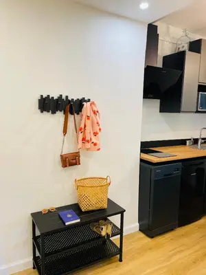 a kitchen with black cabinets and a black table at L’Écrin in Aix-en-Provence