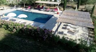 an overhead view of a swimming pool with chairs and umbrellas at mas clair de lune in Saint-Rémy-de-Provence