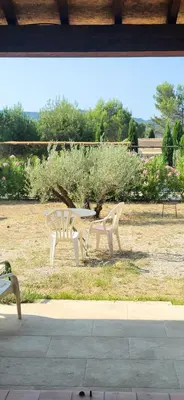 two white park benches sitting in a field at mas clair de lune in Saint-Rémy-de-Provence