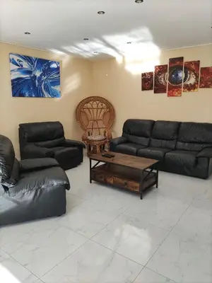 a living room with black couches and a coffee table at Maison confortable à Ansouis dans Le Luberon in Ansouis