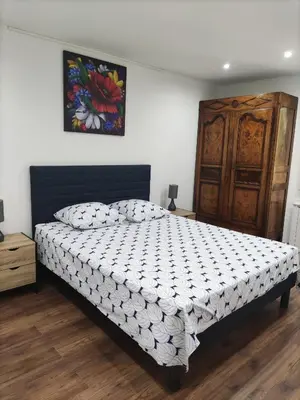 a bedroom with a bed and a painting on the wall at Maison confortable à Ansouis dans Le Luberon in Ansouis