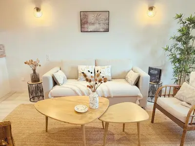 a living room with a couch and a table at ''' Impasse d'un Instant ''' 8min Aix - Clim & Parking in Venelles