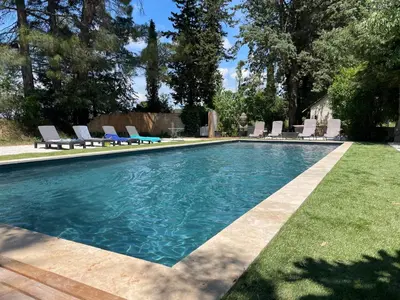 a swimming pool with lounge chairs in a yard at Superbe bas de villaIX - Maison Odonata in Aix-en-Provence