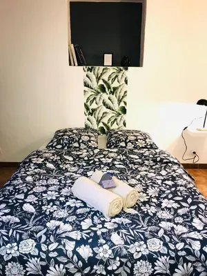 a bed with a blue and white blanket with towels on it at Superbe bas de villaIX - Maison Odonata in Aix-en-Provence