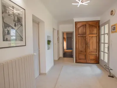 a hallway with a wooden door in a house at Le grand Liodrey in Céreste