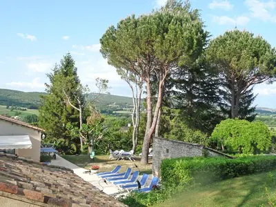 a group of lounge chairs and trees in a yard at Liodrey in Céreste