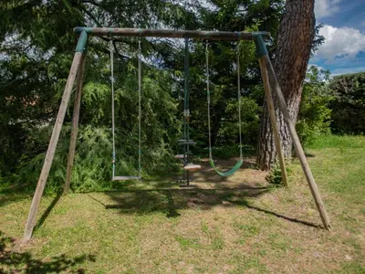 an old swing in a yard with a tree at Liodrey in Céreste