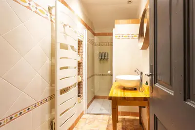 a small bathroom with a sink and a shower at Le Gîte du Carmel in Carpentras