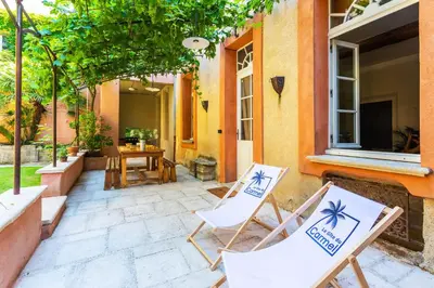 two chairs sitting on the patio of a house at Le Gîte du Carmel in Carpentras