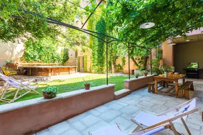 an outdoor patio with chairs and a table at Le Gîte du Carmel in Carpentras