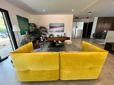 a living room with yellow chairs and a table at Luxury Villa with Pool en Provence in Le Puy-Sainte-Réparade