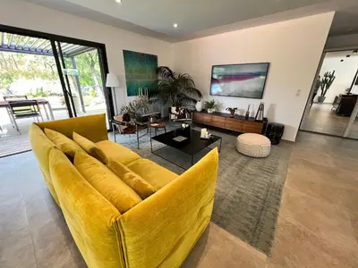 a living room with a yellow couch and a table at Luxury Villa with Pool en Provence in Le Puy-Sainte-Réparade