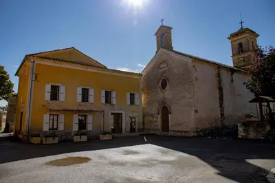 an old building with a tower and a church at L’auberge de Montsalier in Montsalier