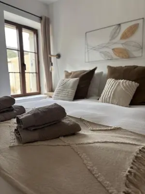 a large white bed with pillows on top of it at L’auberge de Montsalier in Montsalier