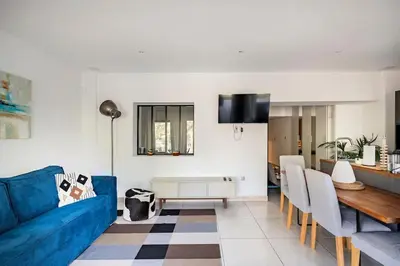 a living room with a blue couch and a table at Entre Aix et Marseille in Rognac