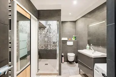 a bathroom with a shower and a toilet and a sink at Entre Aix et Marseille in Rognac