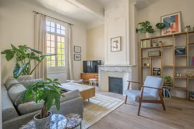 a living room with a couch and a fireplace at Le Cocon Aixois in Aix-en-Provence