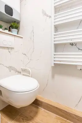 a white bathroom with a toilet and a shower at Le Forbin by La Familia in Aix-en-Provence