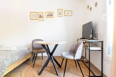 a room with a table and two chairs and a bed at Le Forbin by La Familia in Aix-en-Provence