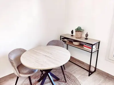 a dining room with a table and two chairs at Le Forbin by La Familia in Aix-en-Provence