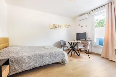 a bedroom with a bed and a table with chairs at Le Forbin by La Familia in Aix-en-Provence