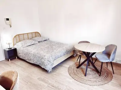 a bedroom with a bed and a table and chairs at Le Forbin by La Familia in Aix-en-Provence