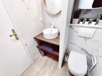 a bathroom with a toilet and a sink and a mirror at Le Forbin by La Familia in Aix-en-Provence
