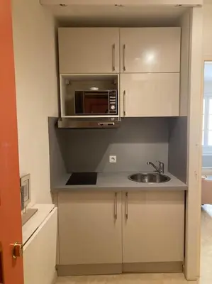 a kitchen with a sink and a microwave at Le Fernandol by La Familia in Aix-en-Provence