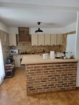 a kitchen with a brick counter and a brick wall at Maison T4, campagne Provençale calme, tout confort in Lambesc