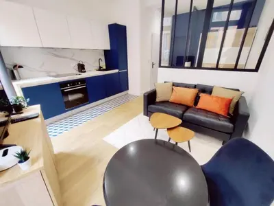 a living room with a couch and a table at Le Boulegon by La Familia in Aix-en-Provence