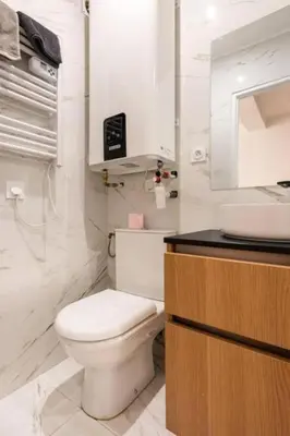 a white bathroom with a toilet and a sink at Le Boulegon by La Familia in Aix-en-Provence