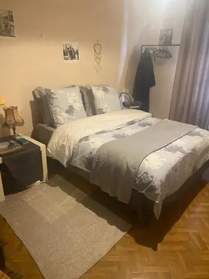a bedroom with a bed and a rug at Quartier Mazarin in Aix-en-Provence